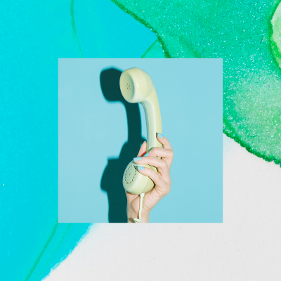 Hand holding phone headset with abstract background