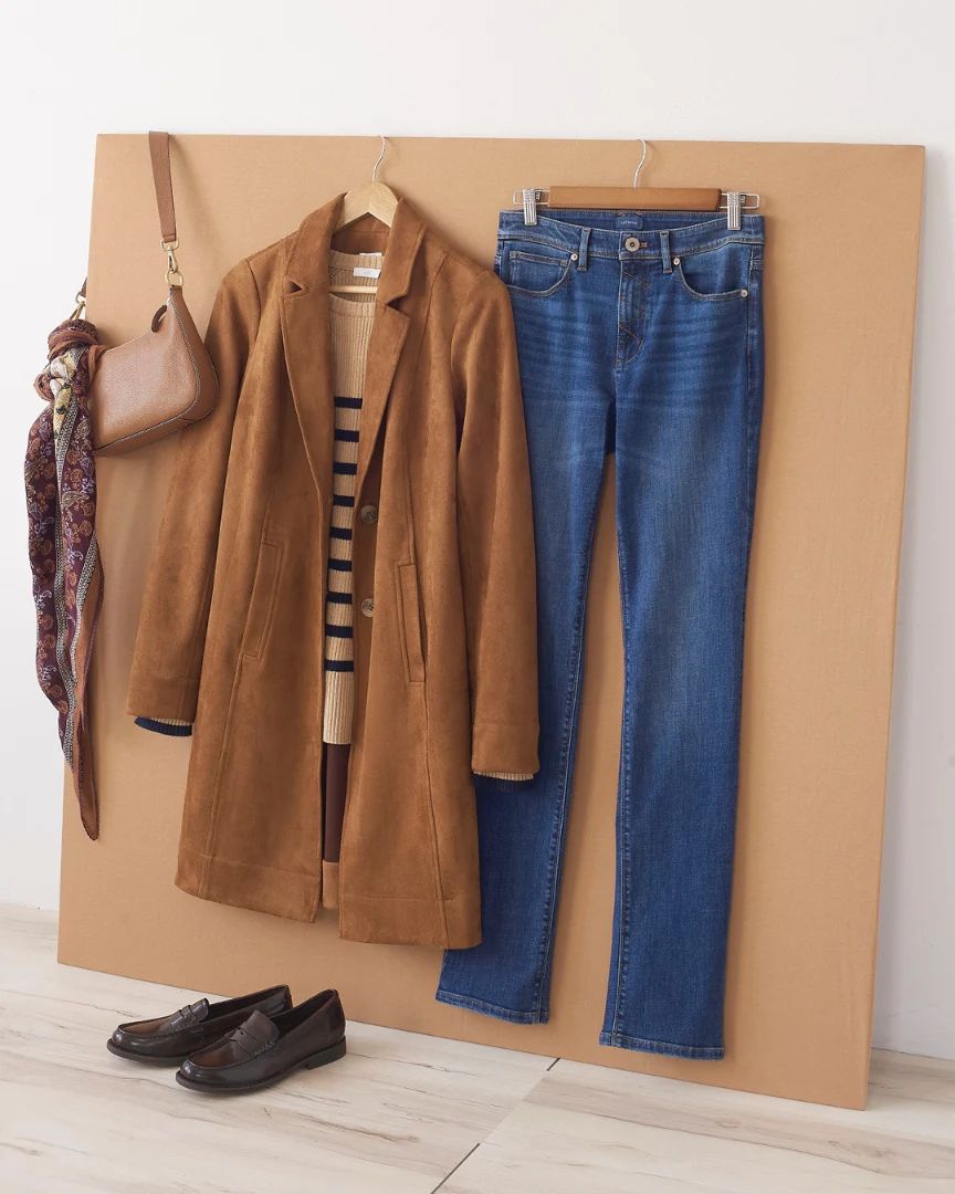 a pair of jeans, coat, and purse hanging on a wall