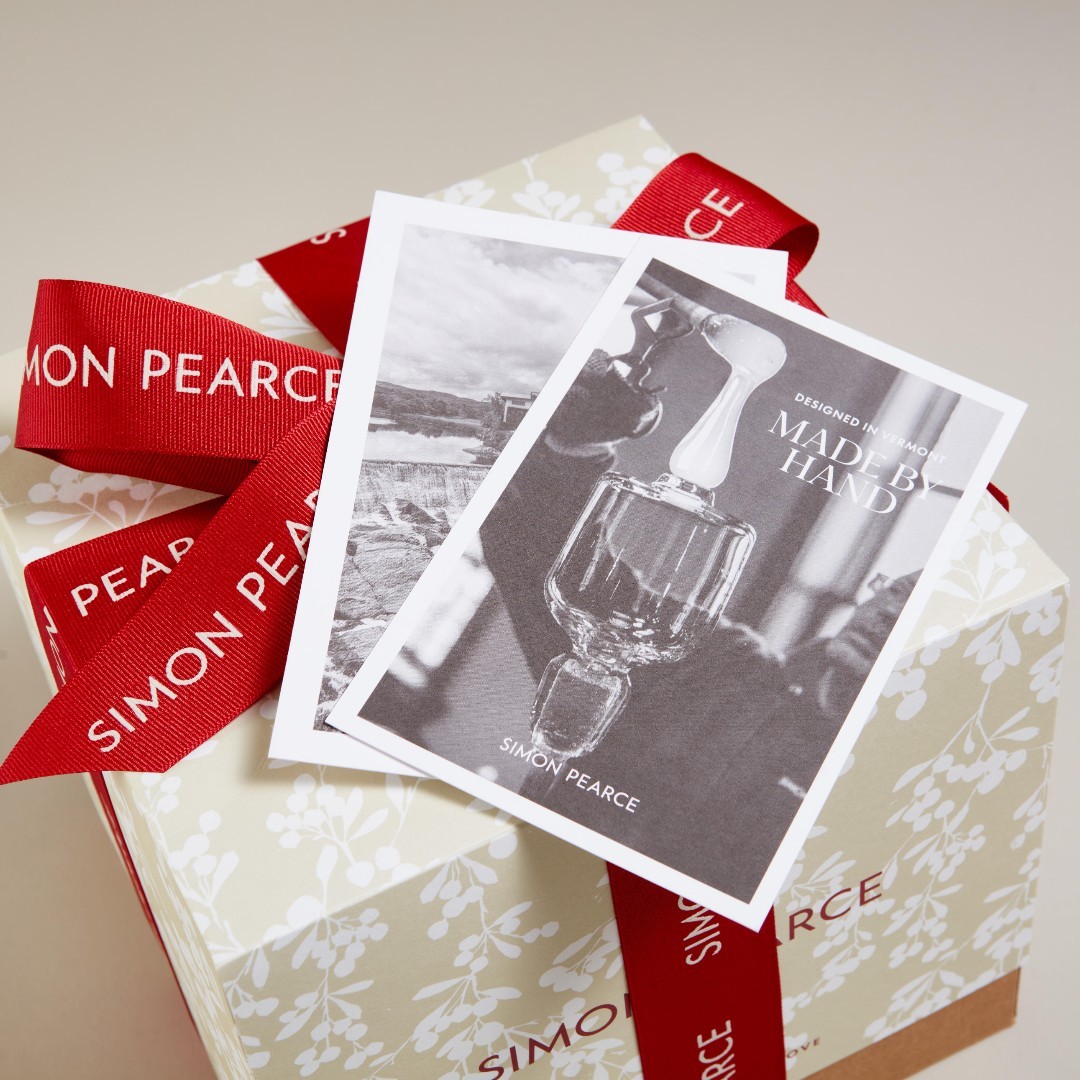 LUX BOND & GREEN a Simon Pearce box wrapped in red ribbon with a card that reads "Designed in Vermont Made By Hand"